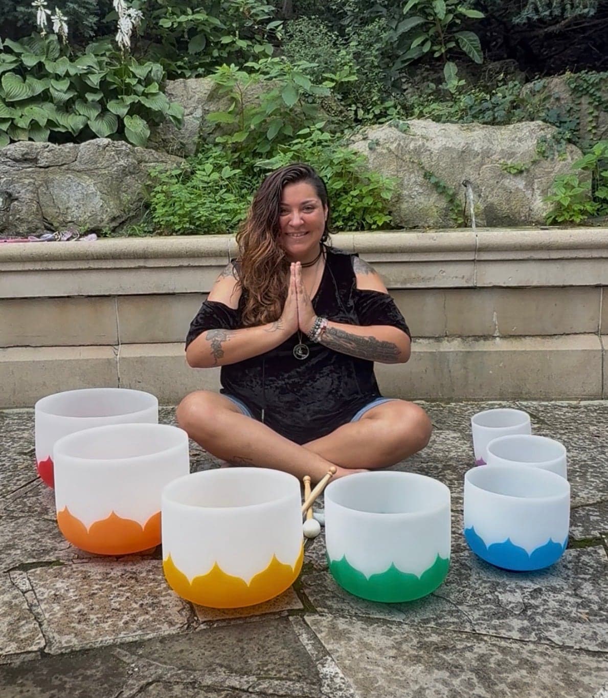 Alicia seated with her crystal singing bowls